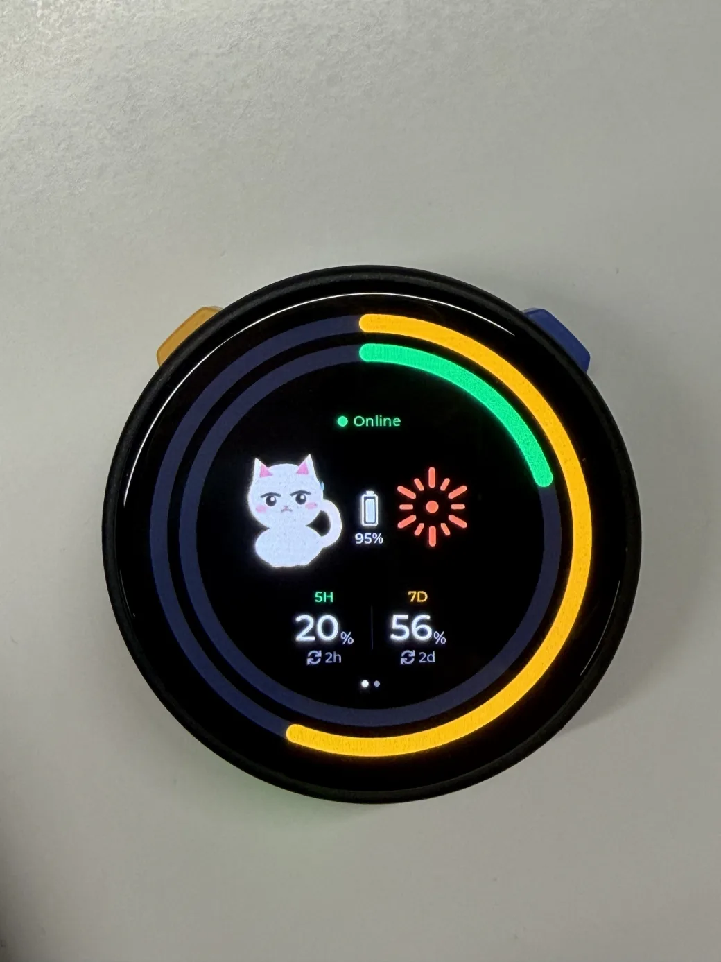 A Tokpet ESP32-S3 desk pet displaying the halo-cat usage rings on its 466×466 round AMOLED screen.