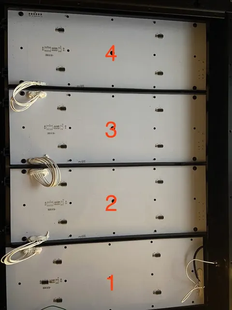 Inside view showing the four LED plates and the 6-pin edge connectors used for wiring