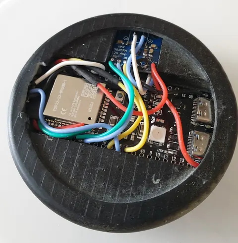 VoicePuck bottom view revealing the internal wiring layout