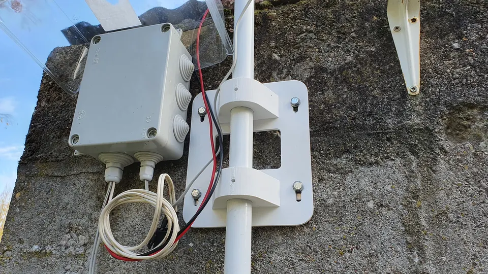 The 3D-printed wall bracket and the power supply box housing the solar charge controller.