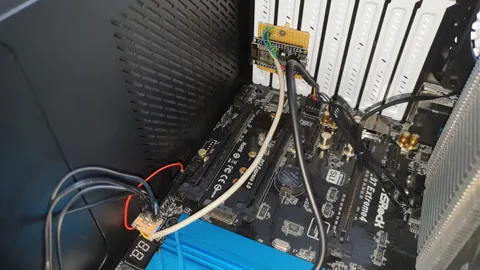 DIY breakout PCB wired to the motherboard's system-panel header for the power button and reset pin connections.