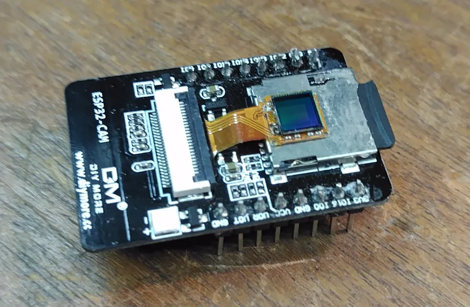 A replacement wide-aperture lens fitted to the ESP32-CAM for improved low-light performance.