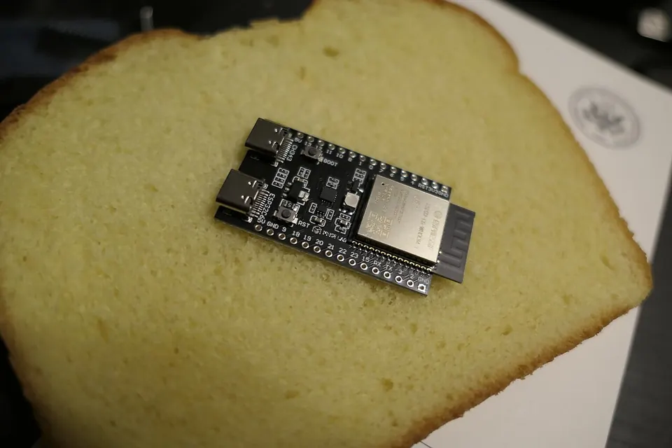 ESP32 development board with camera module attached on breadboard