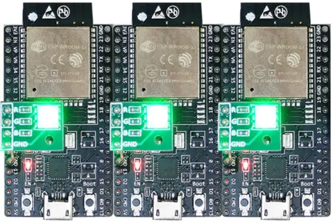 Three ESP32 BLE Mesh nodes powering on with RGB LED green, indicating they are unprovisioned and advertising.