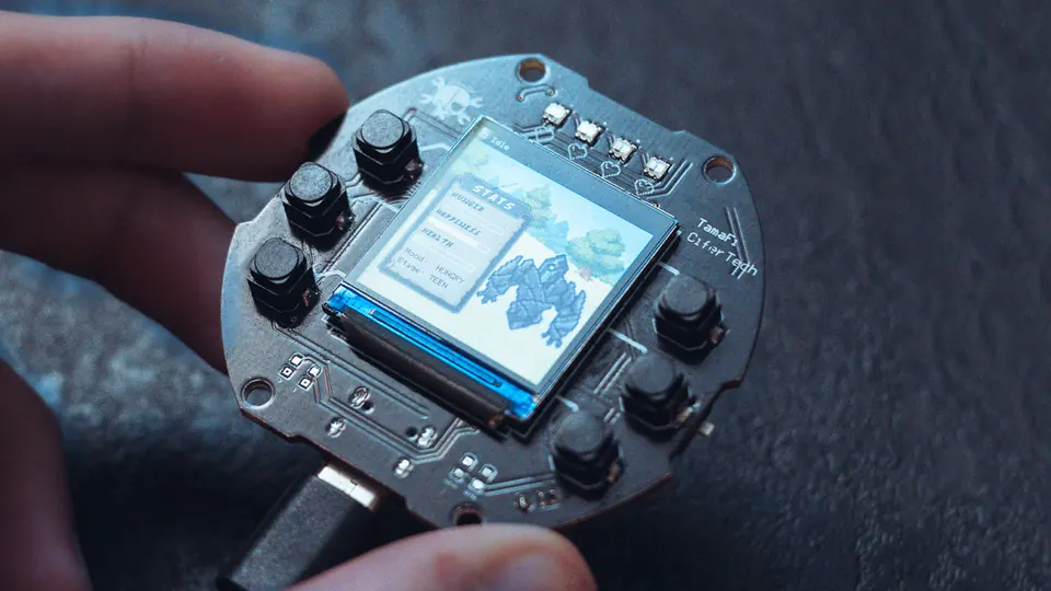 TamaFi V2 assembled device running the full-color TFT pet interface with NeoPixel mood lighting