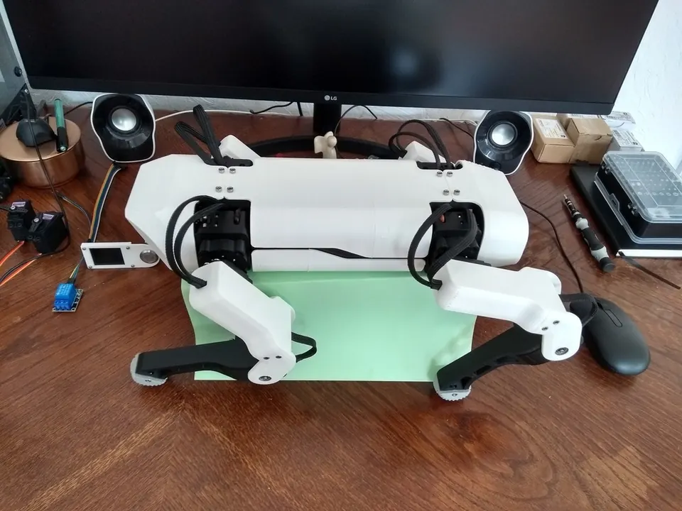 The assembled SpotMicroESP32 quadruped robot, showing the 3D-printed chassis, four articulated legs, and head unit with camera mount.